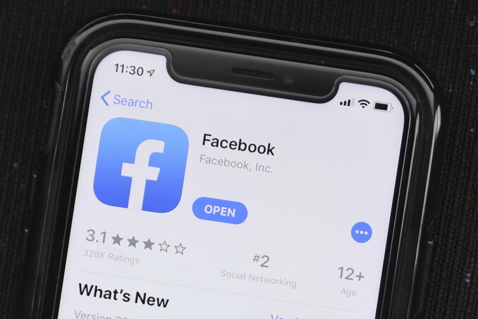 FILE - In this July 30, 2019, file photo, the social media application, Facebook is displayed on Apple's App Store in Chicago.  On Wednesday, July 17, 2020, Several civil-rights and other advocacy groups are calling on large advertisers to stop Facebook a