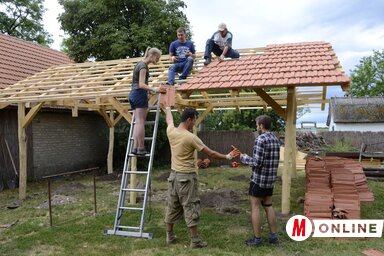 Önkéntesek cserepezik az általuk felépített teraszt (Fotó: Molnár Edvárd)