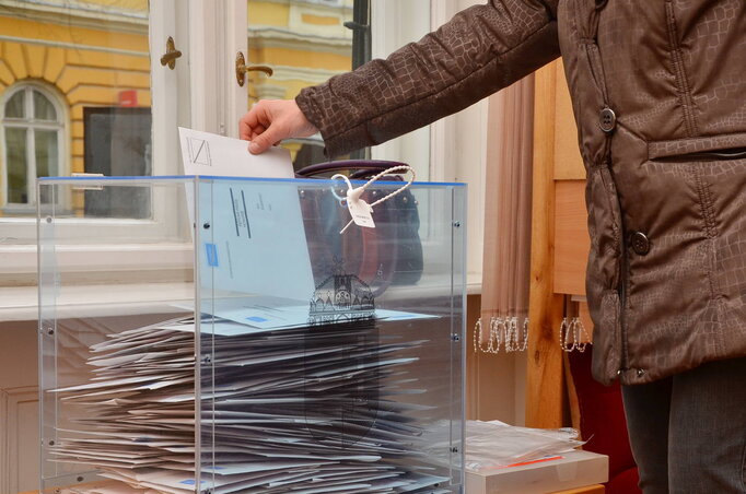 A képen: egy férfi bedobja levélszavazatát a szavazóládába a szabadkai magyar főkonzulátuson