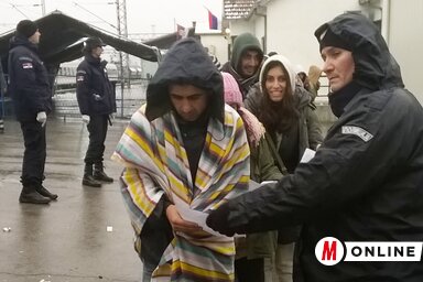 A szerb és a horvát rendőrök közösen ellenőrzik a menekültek Preševóban kiállított regisztrációs dokumentumait, mielőtt felengednék őket a vonatra (Németh Zoltán felvétele)