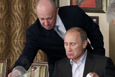 FILE Yevgeny Prigozhin, top, serves food to then-Russian Prime Minister Vladimir Putin at Prigozhin's restaurant outside Moscow, Russia on Nov. 11, 2011. Prigozhin, the owner of the Wagner p