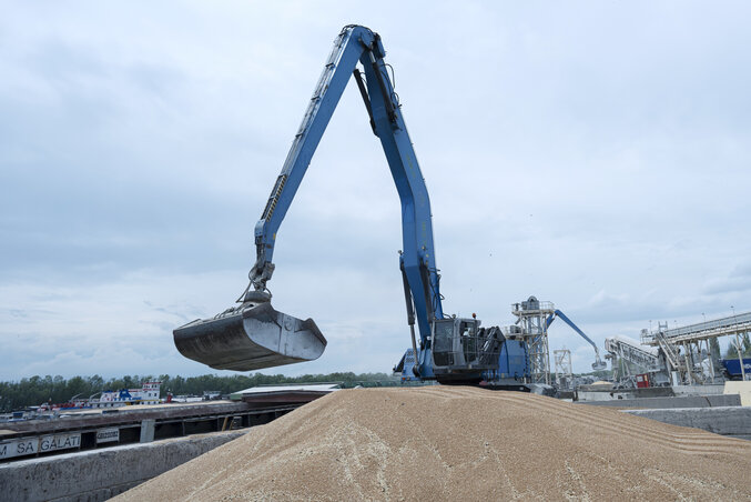FILE - An excavator loads grain into a cargo ship at a grain port in Izmail, Ukraine, on April 26, 2023. Russia has suspended on Monday July 17, 2023 a wartime deal brokered by the U.N. and FILE - An excavator loads grain into a cargo ship at a grain port in Izmail, Ukraine, on April 26, 2023. Russia has suspended on Monday July 17, 2023 a wartime deal brokered by the U.N. and