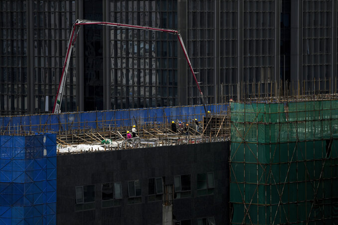 Workers use a machine to pour cement on a reconstruction office building in Beijing on Aug. 6, 2023. China’s government skipped giving an update on a politically sensitive spike in unemploym Workers use a machine to pour cement on a reconstruction office building in Beijing on Aug. 6, 2023. China’s government skipped giving an update on a politically sensitive spike in unemploym