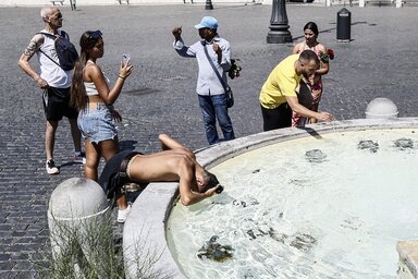 Tourists cool off at a fountain in Rome's Piazza del Popolo, as the African anticyclone is rising temperatures again all over Italy, starting a new heat wave. (Cecilia Fabiano/LaPresse via A