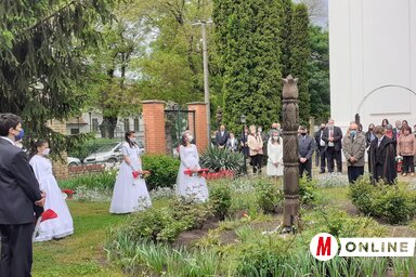 A konfirmációs istentisztelet után az ünneplő gyülekezet a Kisújszállásról származó ősök előtt tisztelegve megkoszorúzta a templomkertben álló kopjafát (Kazinczy Paszterkó Diana felvétele)