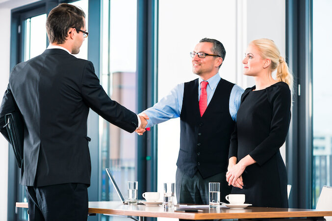 Business - young man in job interview for hiring, welcomes, Boss or Senior and his female Assistant in their office Business - young man in job interview for hiring, welcomes, Boss or Senior and his female Assistant in their office