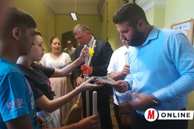 A BUM aktivistái az ülés előtt söprűk osztogatásával ösztönözték a képviselőket a dokumentum elfogadására (Fehér Rózsa felvétele)