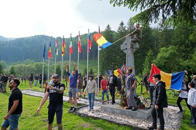 A székelyek élőláncát áttörő román temetőfoglalók egyike a kelta keresztet ábrázoló „ortodox emlékműn” (Fotó: MTI)
