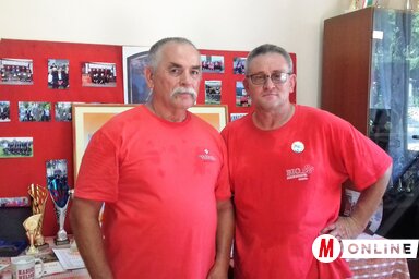 Horváth Mátyás, a Gunarasi Önkéntes Tűzoltó Testület elnöke, és Vida Róbert parancsnok, háttérben a szervezet több évtizedes relikviáit, fényképes emlékeit bemutató kiállítás (Kazinczy Paszterkó DIana felvétele)