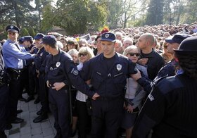 Serbian police officers hold back Tito supporters following the funeral of his widow, former Yugoslavia's first lady Jovanka Broz, in Belgrade, Serbia, Saturday, Oct. 26, 2013. Broz was laid to rest Saturday near the grave of her husband Josip Broz Tito, 