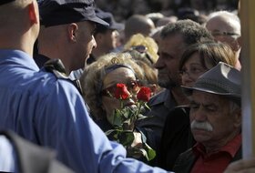 Serbian police officers push back Tito's supporters after the funeral of Jovanka Broz's, widow of the former Yugoslav communist leader Josip Broz Tito, in Belgrade, Serbia, Saturday, Oct. 26, 2013. Former Yugoslavia's first lady Jovanka Broz was laid to r